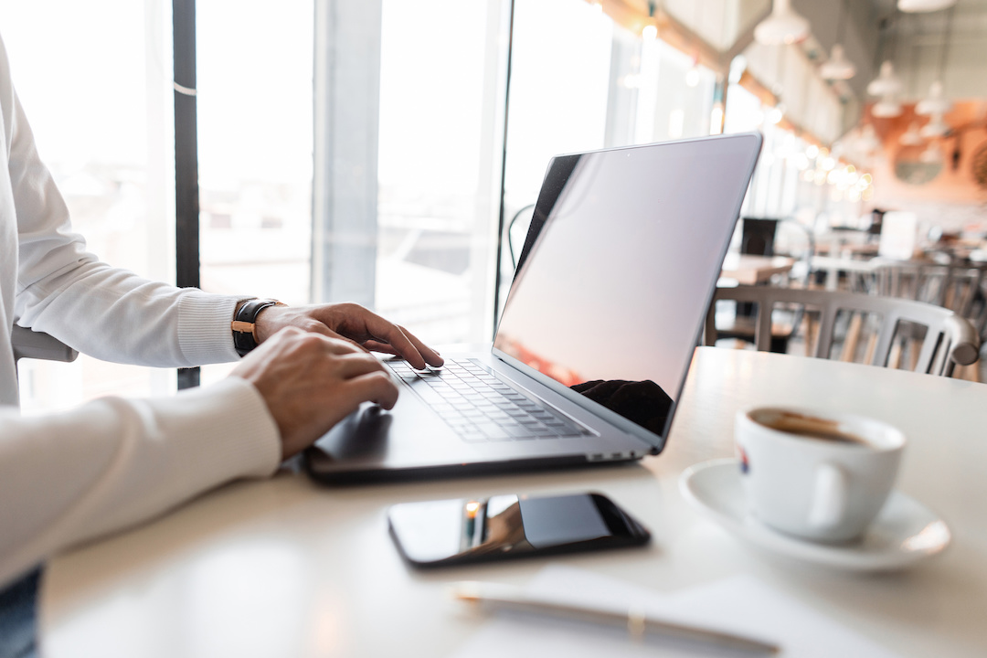 Man working remotely cafe coffee house on laptop