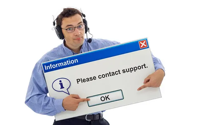 Man wearing headset holding a sign that reads 'Please Contact Support'.