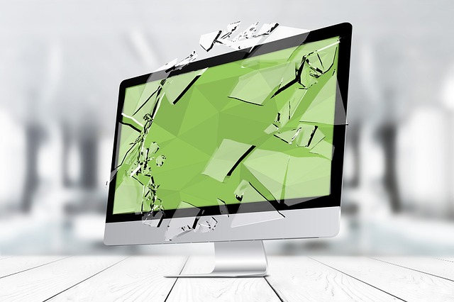 Stylized graphic of a computer monitor with a pane of glass shattering in front of the screen