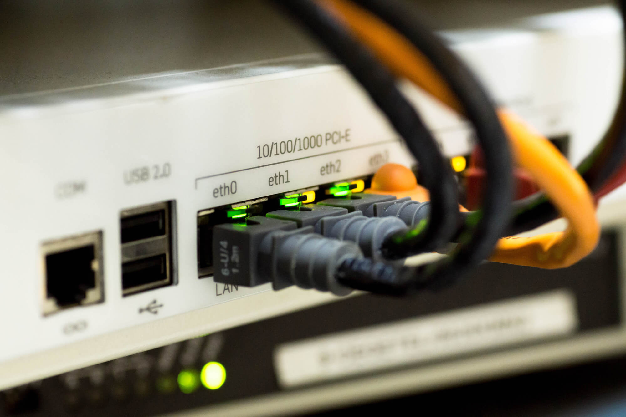 Close up view of network Ethernet cables plugged into ports on a switch/router