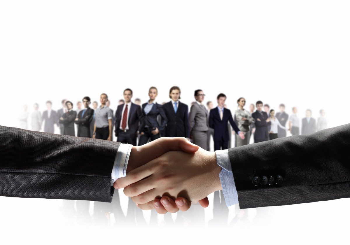 Businesspeople looking at two hand shaking hands