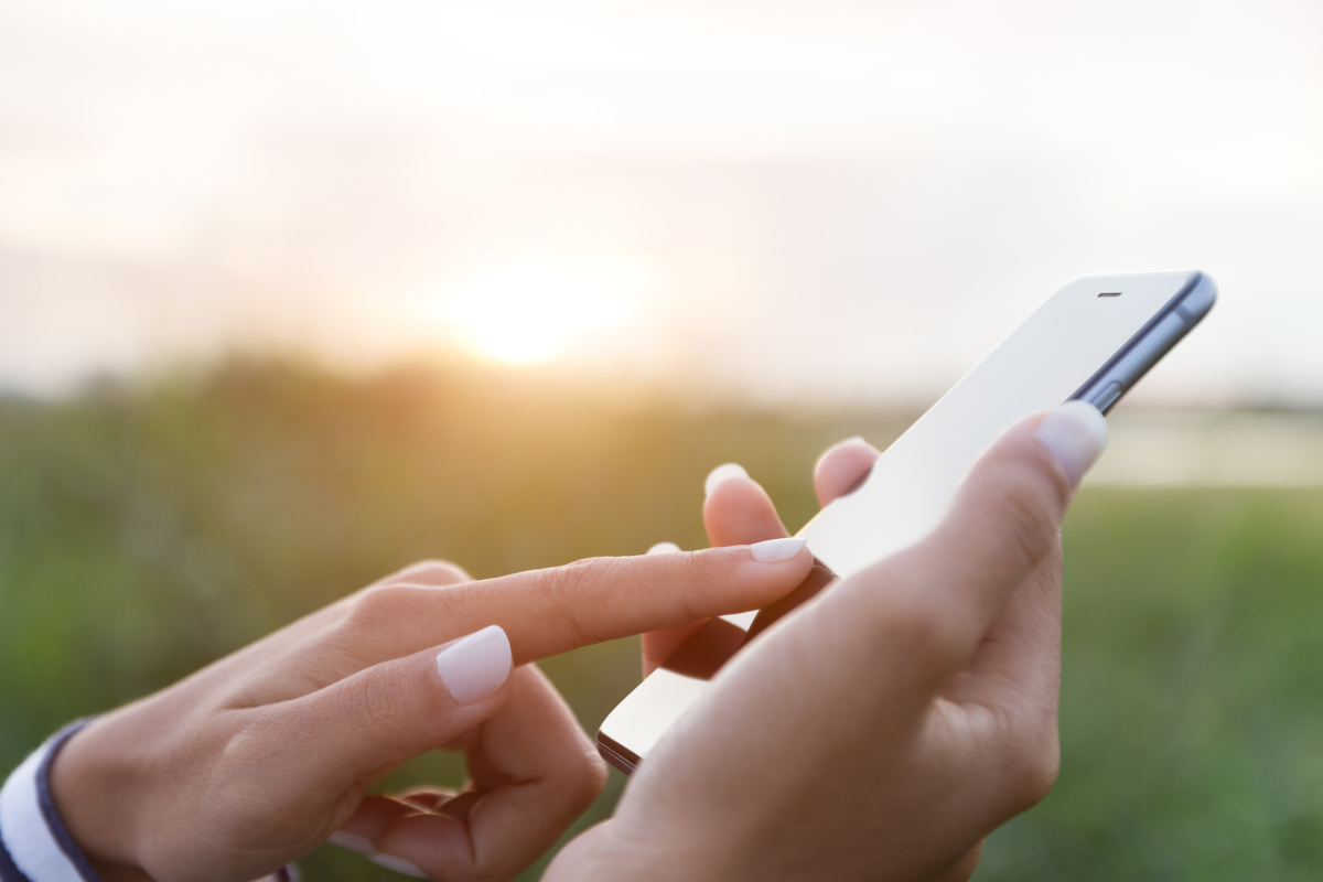 Woman's hand using mobile phone