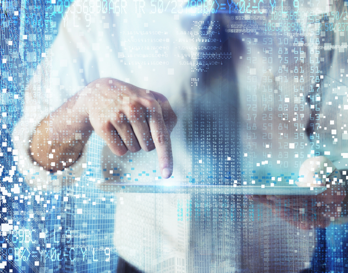 A man in a dress shirt and tie with the sleeves rolled up point his finger down towards a tablet he is holding as numbers along with white and blue block fill the foreground around him