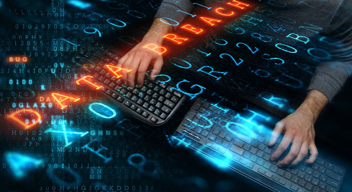 Hacker typing with data security keywords floating