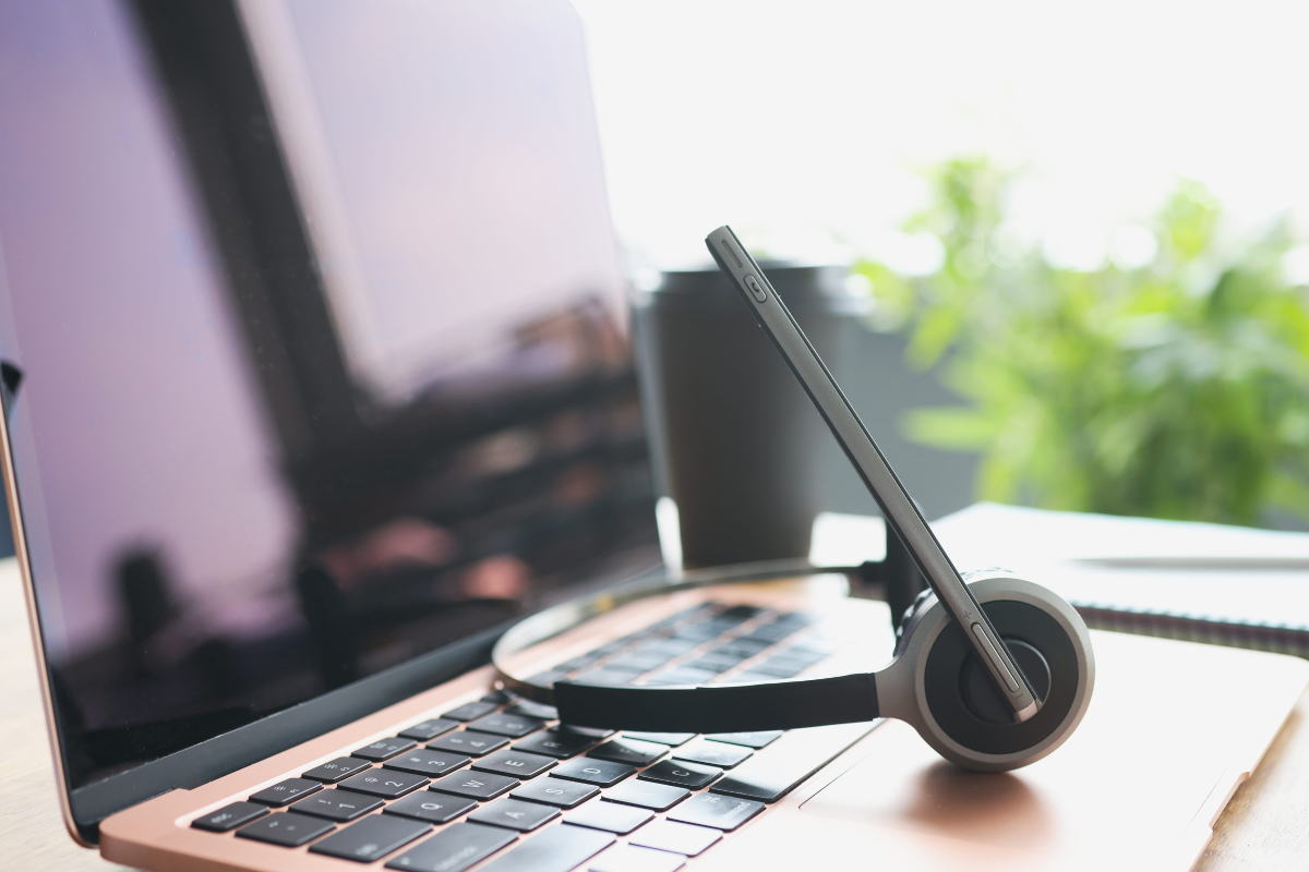 Headset resting on a laptop keyboard.