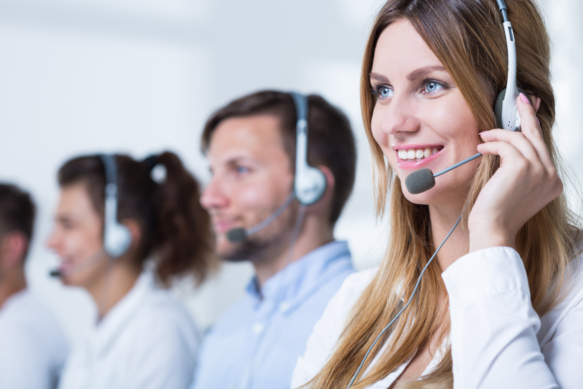 A group of employees with headsets answering calls