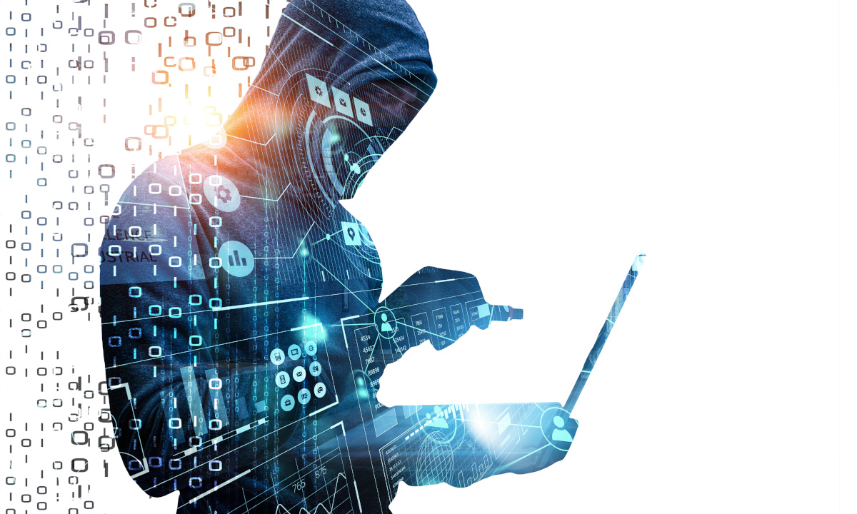 A person in a hoodie holding a laptop with one hand while the other draws a USB closer, with a stylized binary overlaid on top of the figure