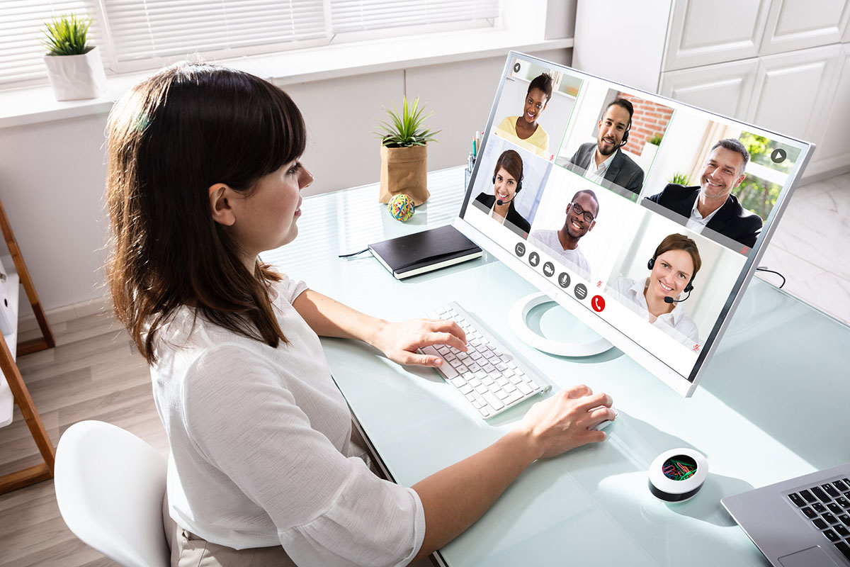 Woman at computer in home office on video conference call.