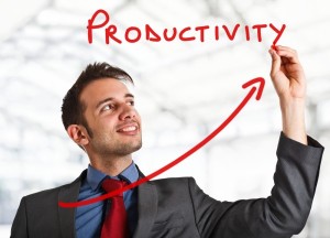 Businessman writing 'Productivity' in the air in red, with an arrow swooping up to his hand