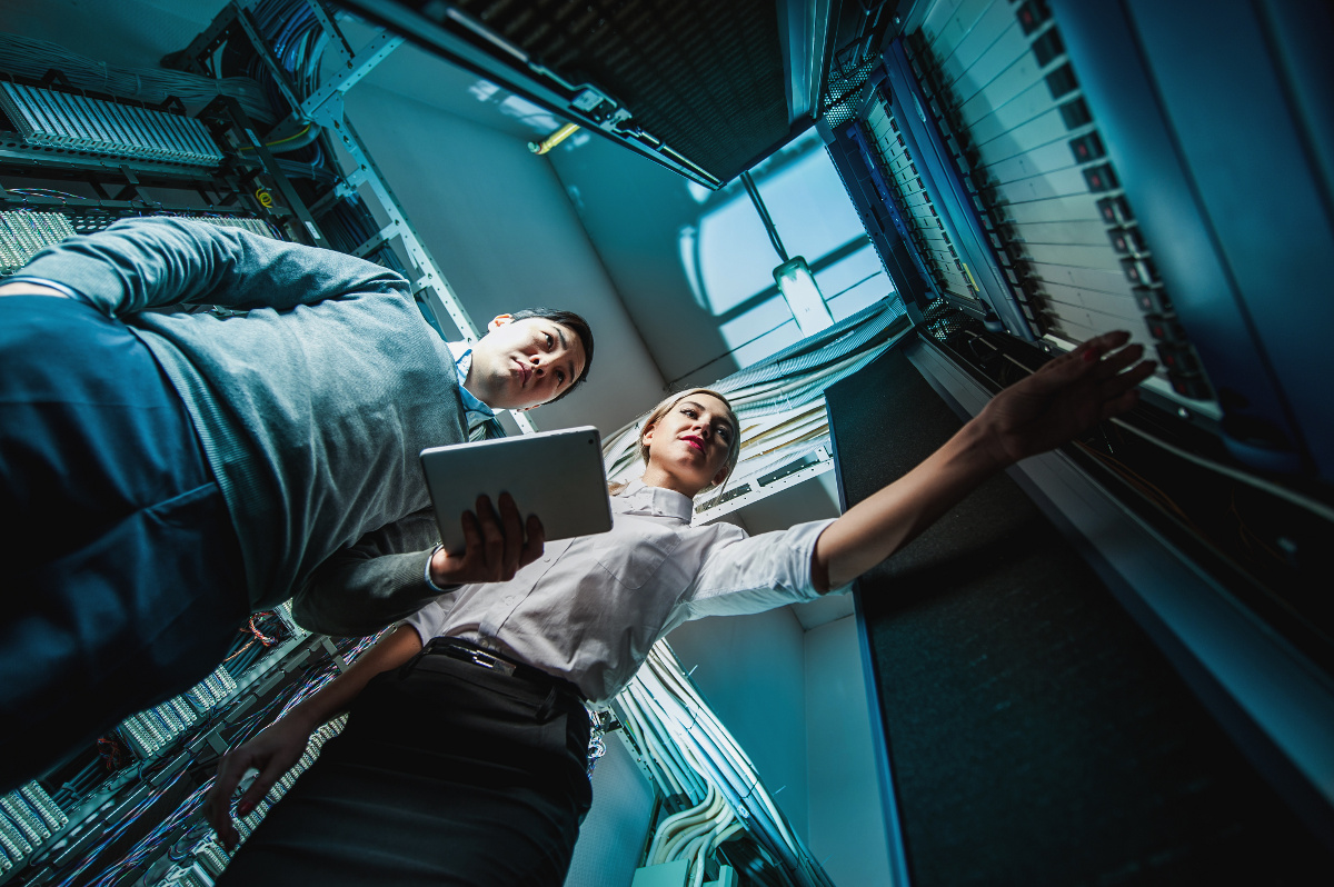 Male and Female Techs Working in a Server Room