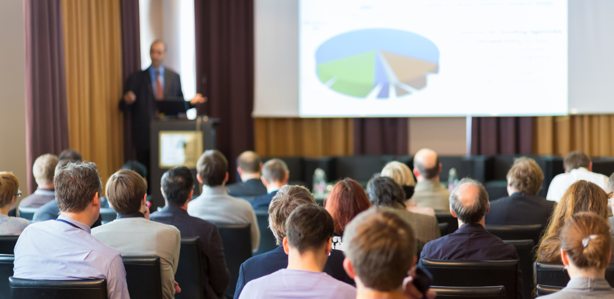 A speaker giving a presentation to a group of people