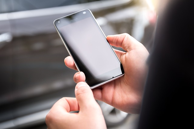 Close up of a businessman holding a Microsoft smartphone in his hands