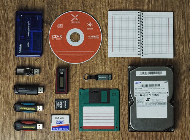 An array of storage media devices, including several USB sticks, laid out on a desk